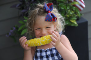 Little girl eating corn, hllf, the feed